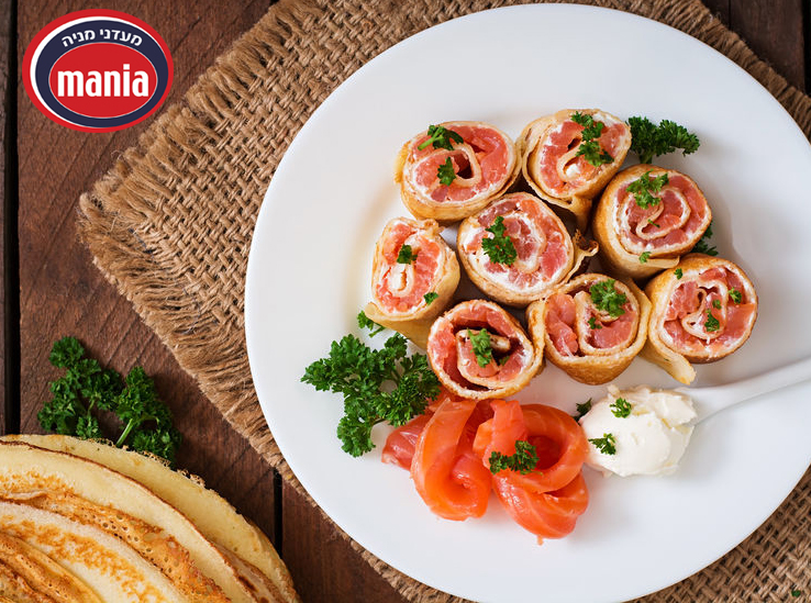 Appetizing pancakes with salmon and cream cheese "Philadelphia". Top view