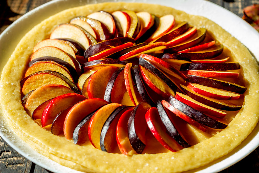 Cooking plum apple pie. Raw pie. Dough. Recipes. Vegetarian food Dark photo